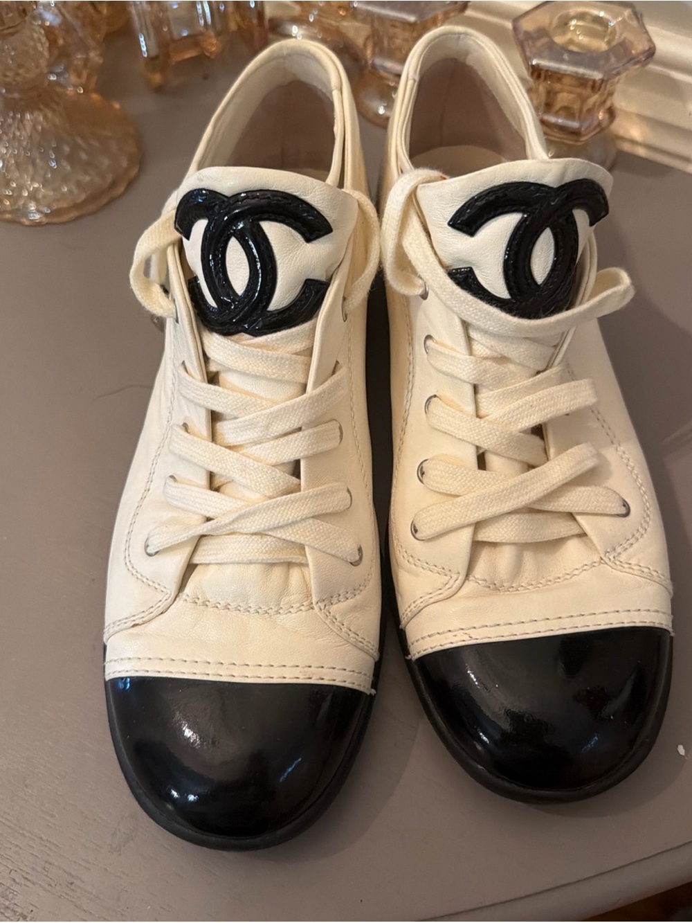 CHANEL Ivory Sneakers with Black Cap Toe and CC Logo